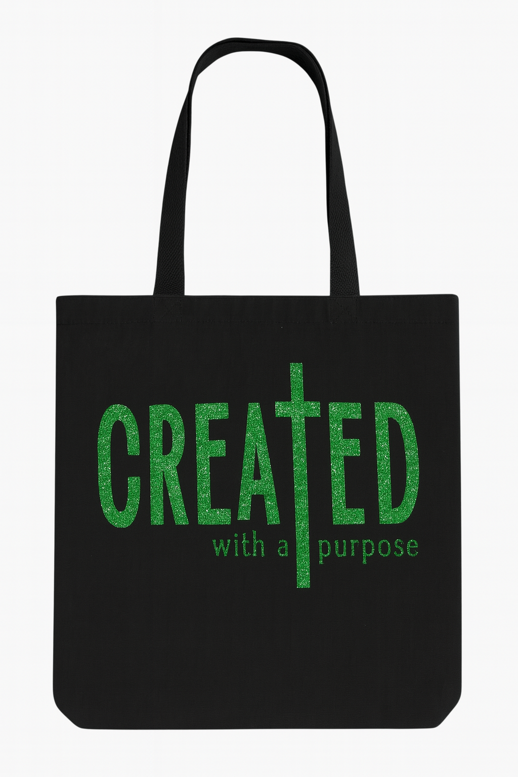 Black tote bag with green text 'CREATED with a purpose' on a white background