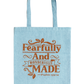Light blue tote bag with 'Fearfully and Wonderfully Made' text on a white background