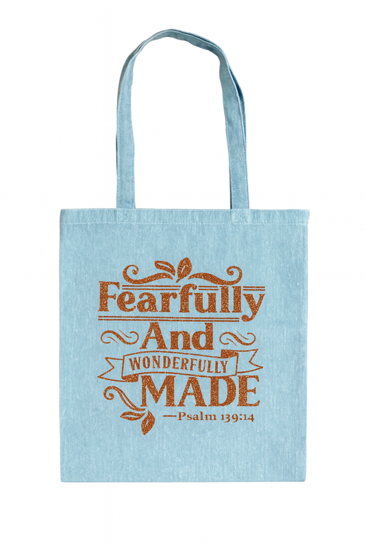 Light blue tote bag with 'Fearfully and Wonderfully Made' text on a white background