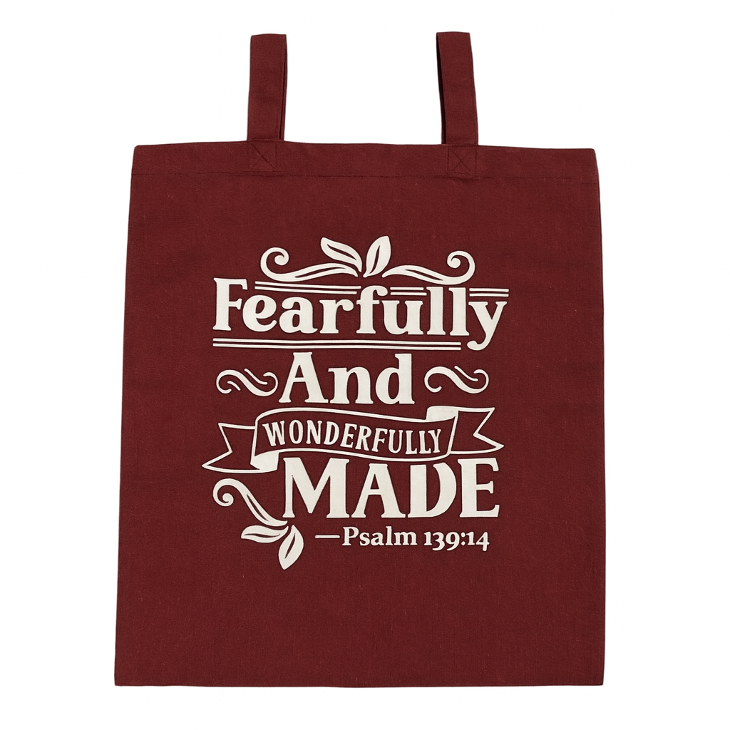 Maroon tote bag with white text 'Fearfully And Wonderfully Made Psalm 139:14' on a white background