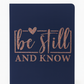 Navy blue notebook with 'be still and know' text in rose gold on a white background