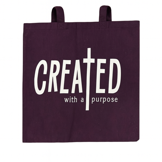 Purple tote bag with 'CREATED with a purpose' text on a white background